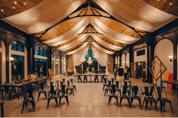 Grove Station interior with draped ceiling and string lights
