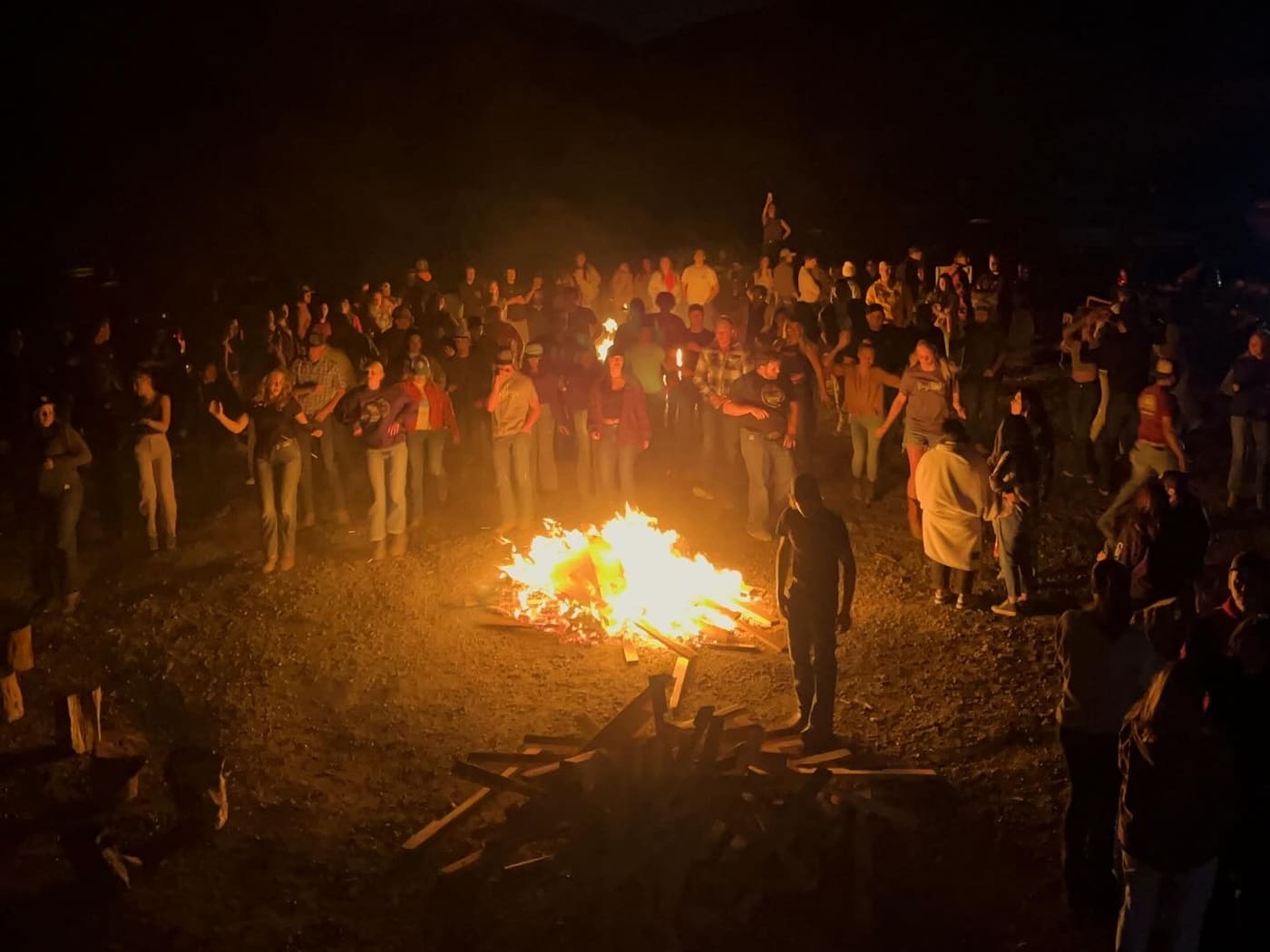 Swingin Dance Co community gathered around a bonfire at night