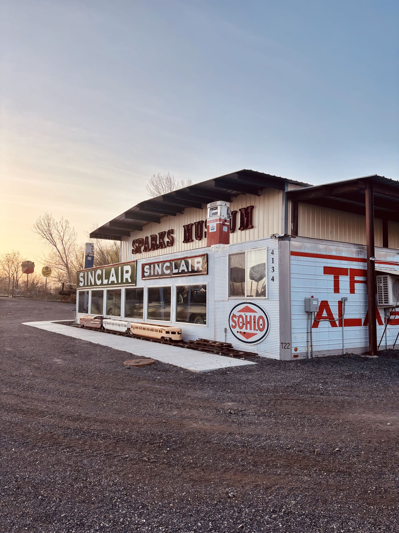 Sparks Museum exterior with Sinclair signs at sunset